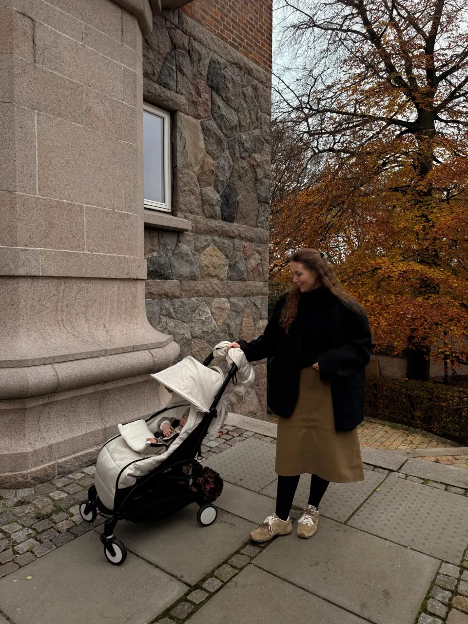 Creator with a stroller on an autumn city walk
