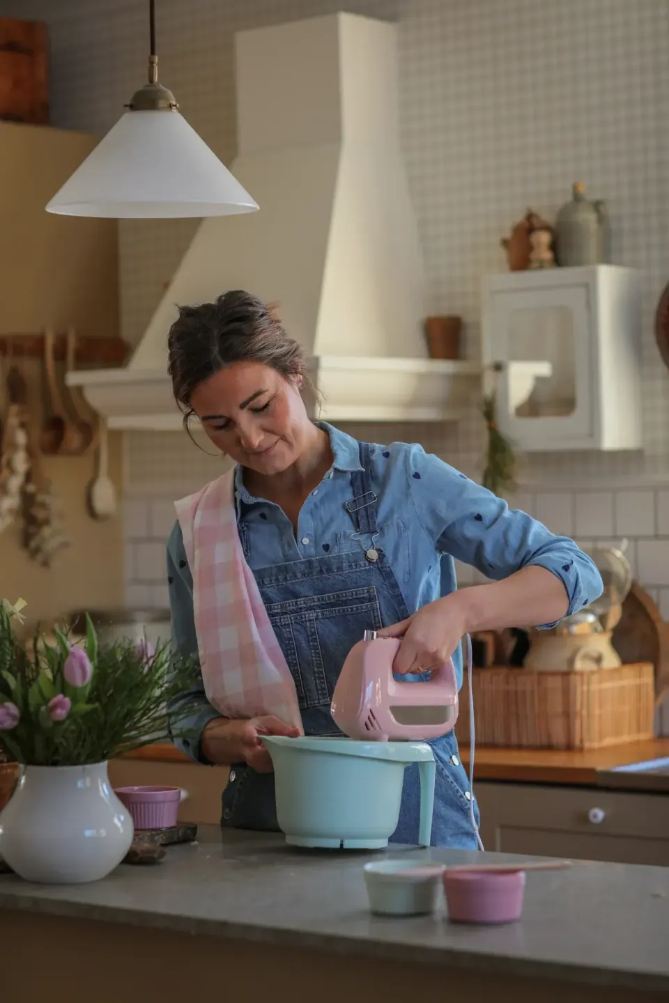 Creator using a mixer to bake in her kitchen