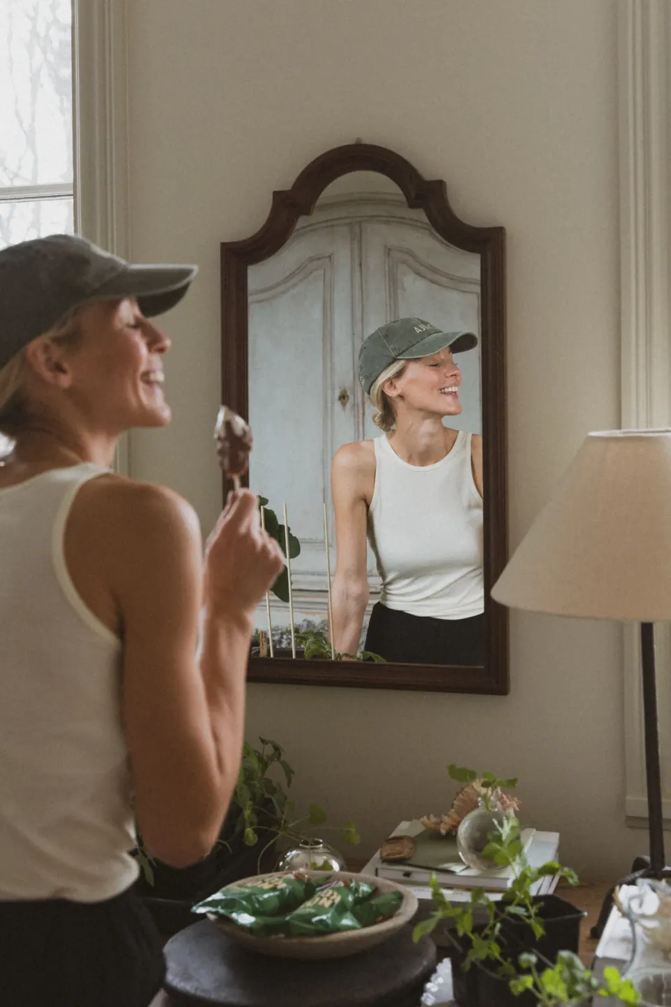 Creator enjoying an ice cream beside a mirror at home